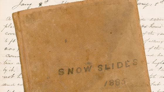 Colour photograph of cover of leather-bound notebook titled 'Snowslides 1885'.